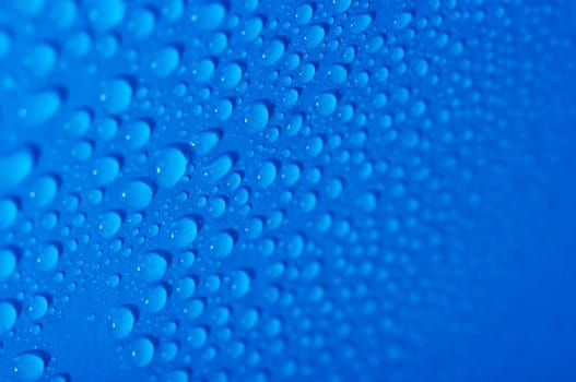 Water drops on a blue surface, shallow DoF