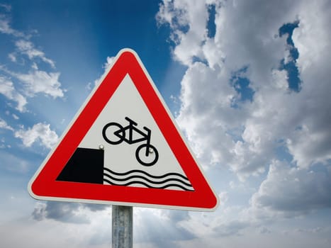 Traffic sign showing a bicycle falling down into the waves