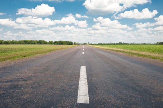 Road. An automobile line and the bright dark blue sky
