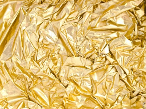 photo of the golden background from crumpled foil