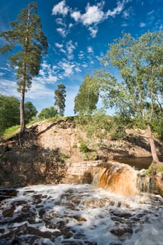 Small boisterous waterfall of a northern river