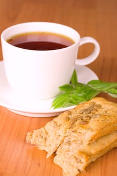 cup of black tea with herbs and bread