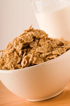 cereals in a bowl with milk glass to the bottom