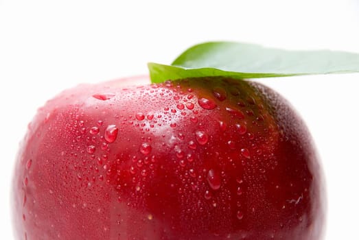 Close-up of ripe fresh red apple with leaf isolated on white