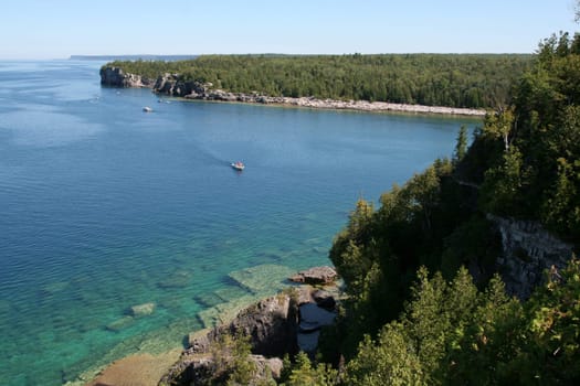 The view from a top the cliffs at Georgian Bay in  Bruce Penisula National Park in Ontario, Canada.  Featuring a bunch of boats.