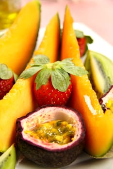 Strawberries and passionfruit with wedges of cantaloupe.