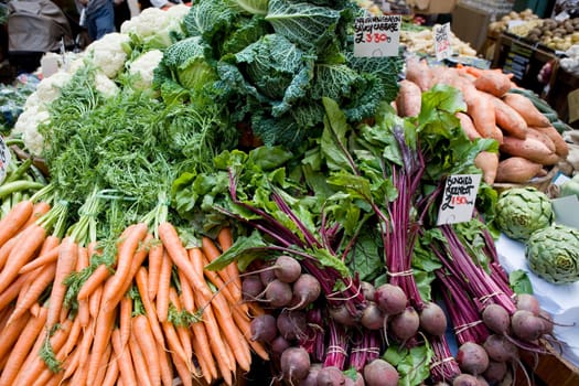 Carrots, Cauliflowers, Broad Beans, Cabbages, Beetroot, Artichokes, Sweet Potatoes, Priced up on a Market Stall