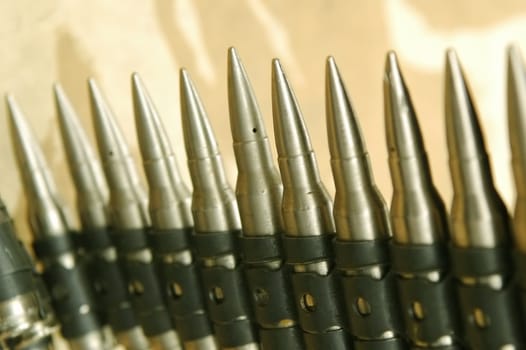 bullet belt ammunition against a camouflage background