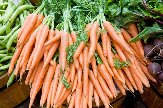 Carrots, beans and beetroot sisplayed on a market stall