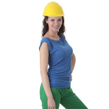 Young female architect or builder wearing a yellow hart hat on a construction site