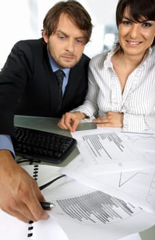 business couple is making an analyses looking at graphics