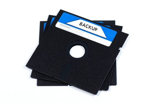 Three very old floppy disks on white background