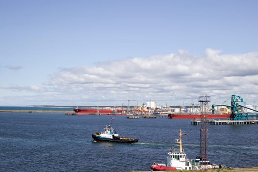 Harbour with many ships, sky with clouds, photo taken during trip near Baltic sea
