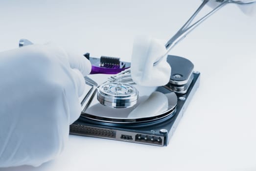 Repair of a hard disk by a surgeon medic.