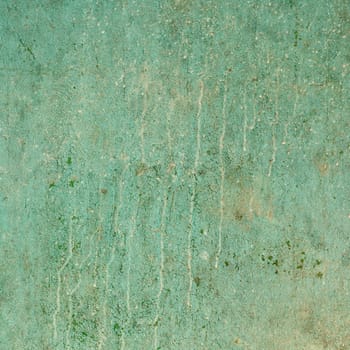 The ancient grunge cracked wall with dirt smudges