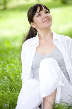 happy young woman relaxing on grass
