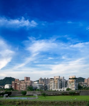 Here is a cityscape of apartment with blue sky.