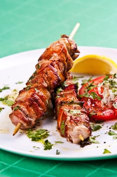 Grilled kebab served with a fresh tomato salad