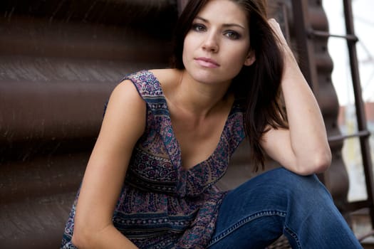 A Beautiful Model sitting with a brown background
