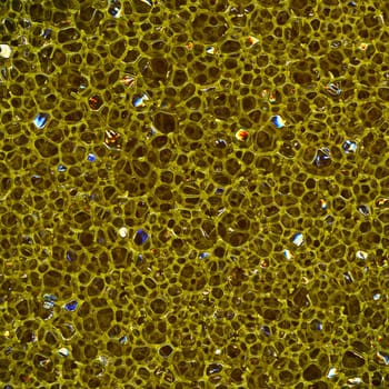 Dark porous sponge made of plastic, close-up