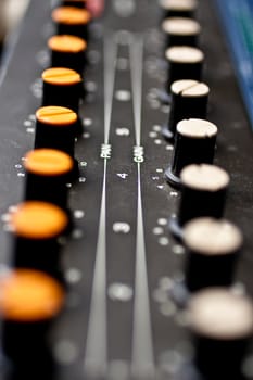 Sound mixer, closeup of the knobs yellow and white knobs