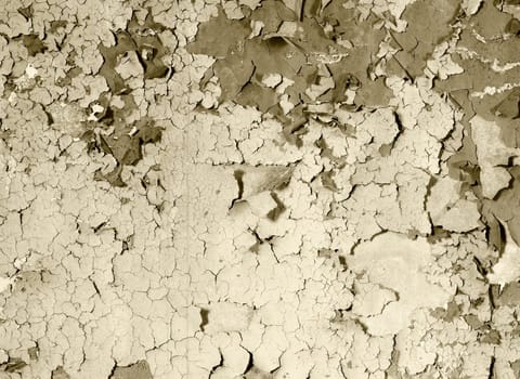 Old damaged paint on a concrete wall - sepia background