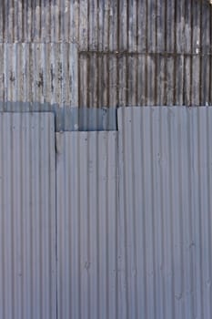 Texture of weathered corrugated sheets of steel riveted together