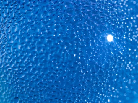 Water droplets formed from condensation inside a blue bottle