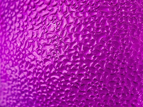Water droplets formed from condensation inside a pink bottle