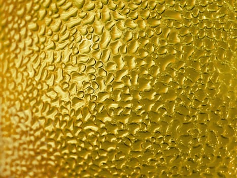 Water droplets formed from condensation inside a bottle gold tone