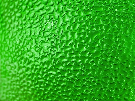 Water droplets formed from condensation inside a green bottle