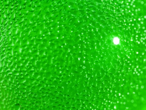 Water droplets formed from condensation inside a green bottle