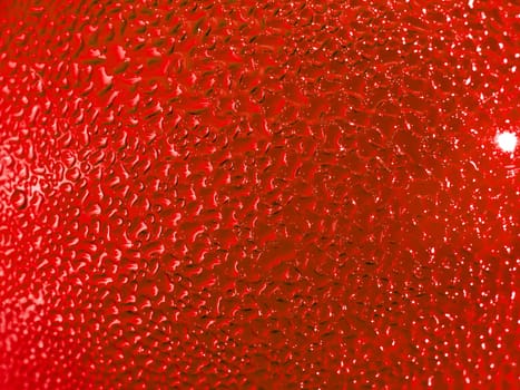 Water droplets formed from condensation inside a red bottle