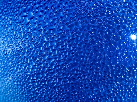 Water droplets formed from condensation inside a blue bottle