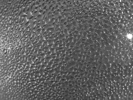 Water droplets formed from condensation inside a bottle silver tone