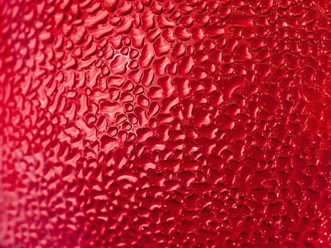 Water droplets formed from condensation inside a red bottle