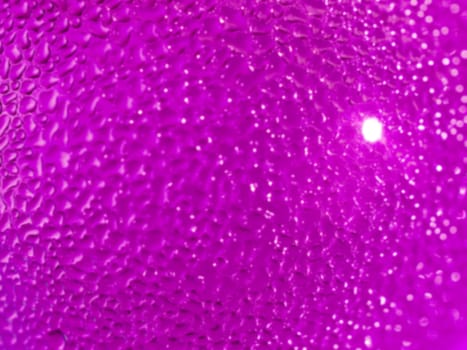 Water droplets formed from condensation inside a pink bottle