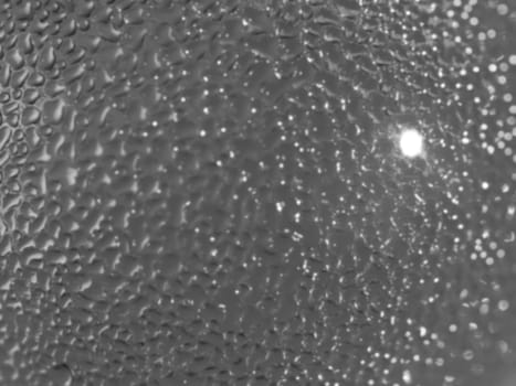 Water droplets formed from condensation inside a bottle silver tone