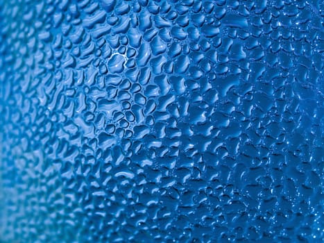 Water droplets formed from condensation inside a blue bottle