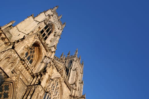 One of the oldest gothic cathedrals in Europe, York Minster Cathedral stands proud against a bright blue summer sky.
