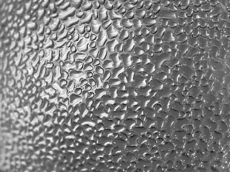 Water droplets formed from condensation inside a bottle silver tone