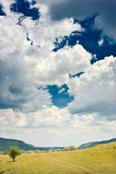 rural landscape with blue sky and clouds on it