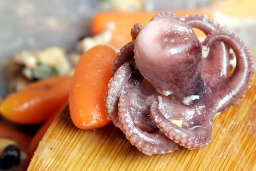 Seafood cooked with vegetables in a pan.