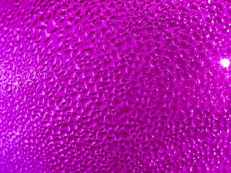 Water droplets formed from condensation inside a pink bottle