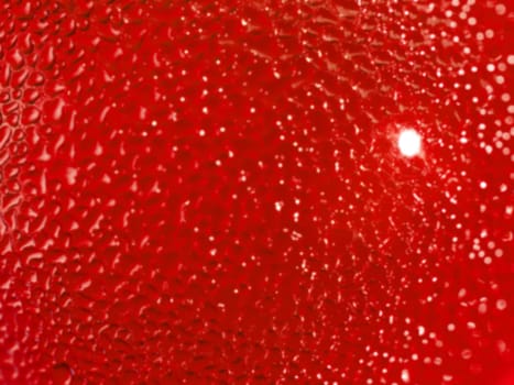 Water droplets formed from condensation inside a red bottle