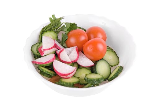 Salad from tomatoes cucumbers and radish on white