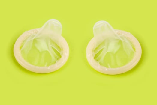 yellow condoms on green background