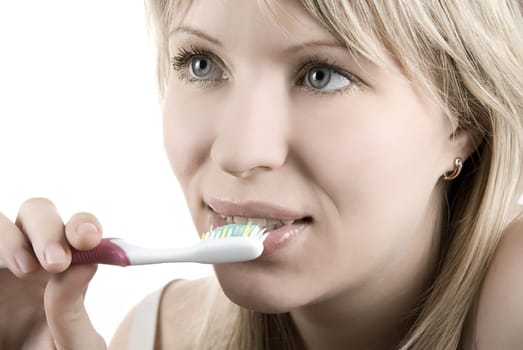 Young beautiful woman clean her teeth