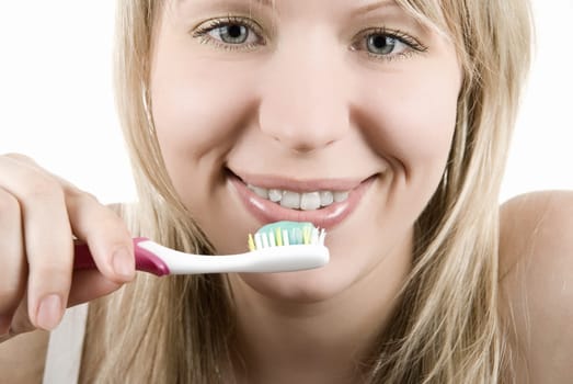 Young beautiful smiling woman with white teeth holding a tooth brush