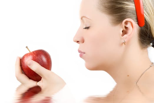 Pretty young woman with apple isolated on white